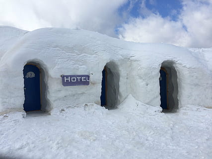 white snow Hotel with blue doors closed at daytime, igloo, ice HD wallpaper