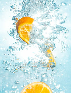 Two slice of orange fruit with some water splash or splatter look fresh and  reflective on the water, white background. AI Generated 26066689 Stock  Photo at Vecteezy