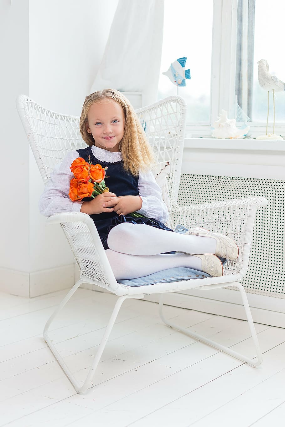 girl holds orange rose flowers while sitting on white metal armchair, HD wallpaper