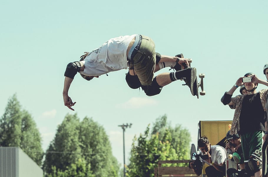 man holding skateboard while doing tricks during daytime, man taking photo of person skateboarding, HD wallpaper