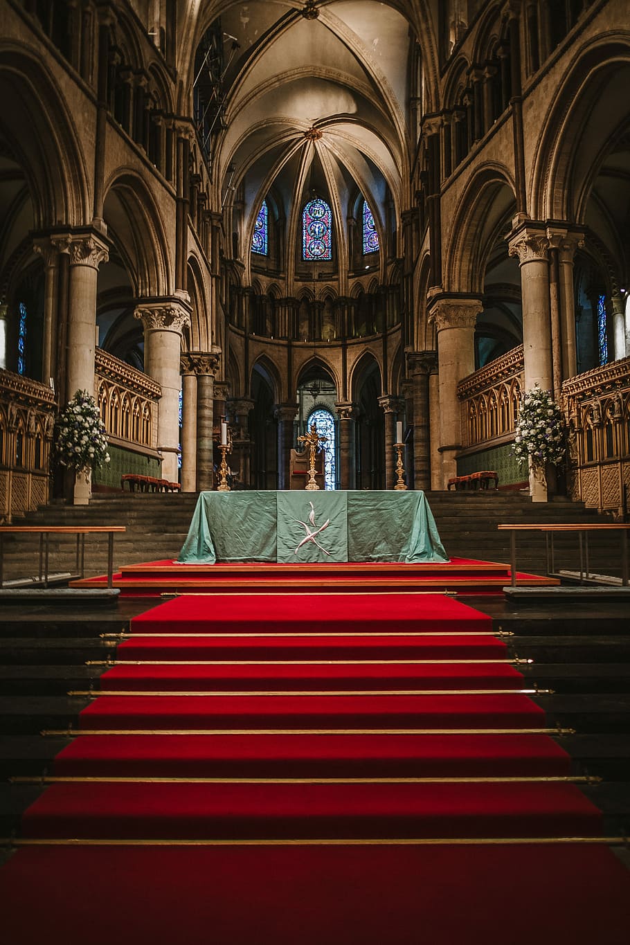 photo of interior of cathedral, red carpet on brown stair, church