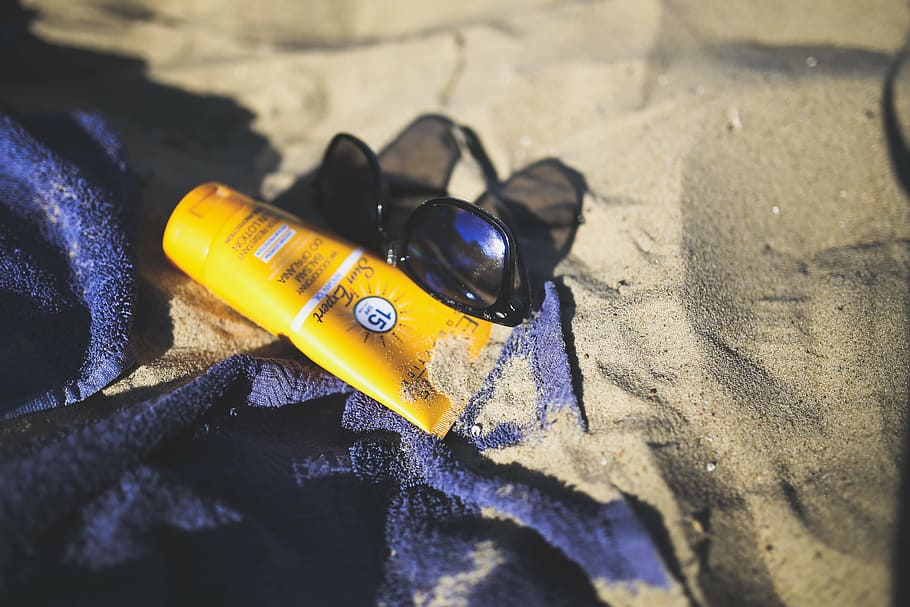 sunglasses and sunblock lotion on sand, sun block, balm, creme HD wallpaper