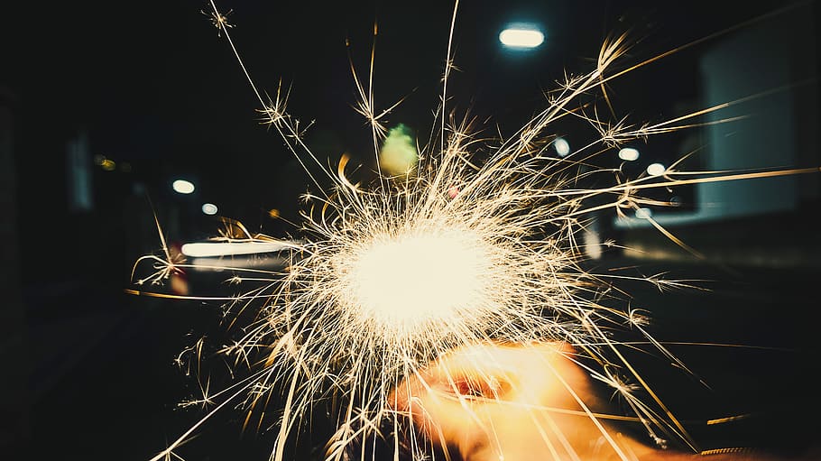 person holding firecracker, person holding fireworks, spark, sparkler HD wallpaper