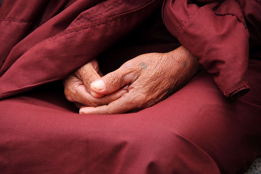 human hand on red textile, monk, hands, faith, person, male, pray, HD wallpaper