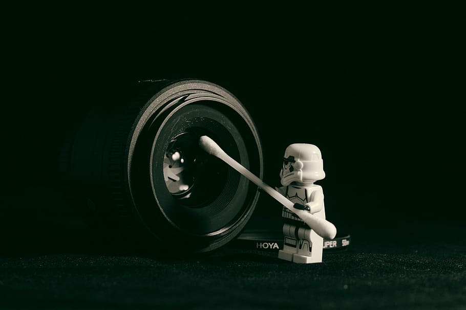 Star Wars Storm Trooper minifig holding cotton swab cleaning camera lens, Storm Trooper holding cotton swab pointed at camera lens