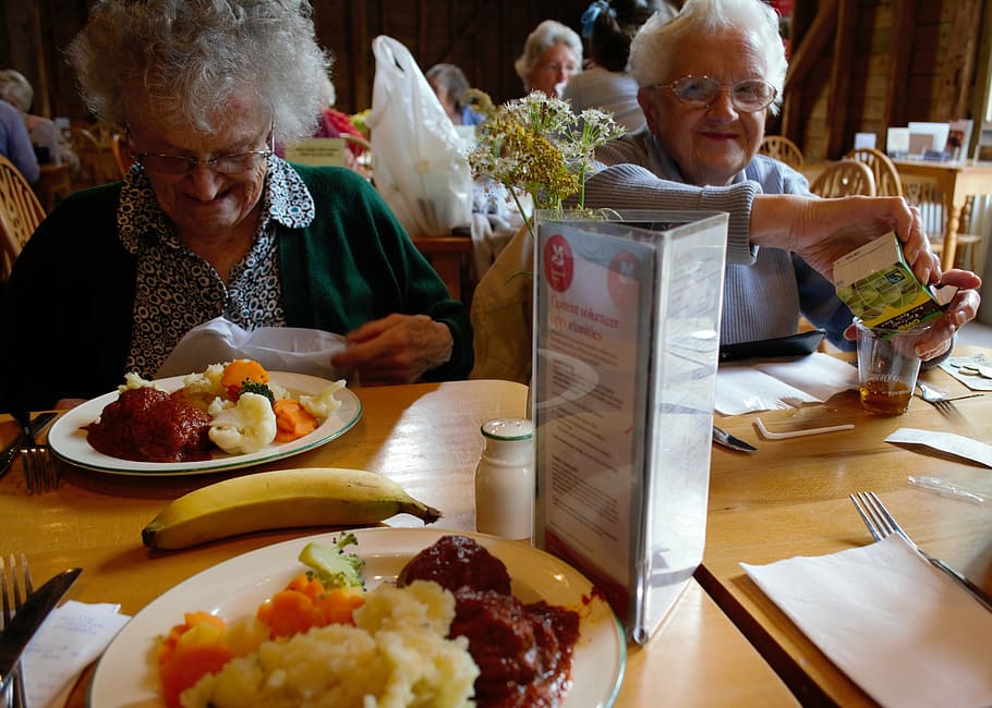 two women sitting front of table, elderly, roast, dinner, senior HD wallpaper