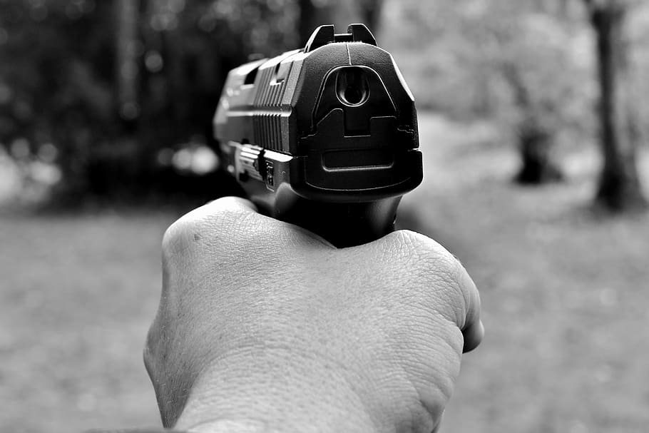 grayscale photography of person holding pistol, weapon, target