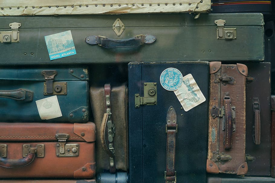 stack of assorted-color suit case lot, arranged luggage bags HD wallpaper
