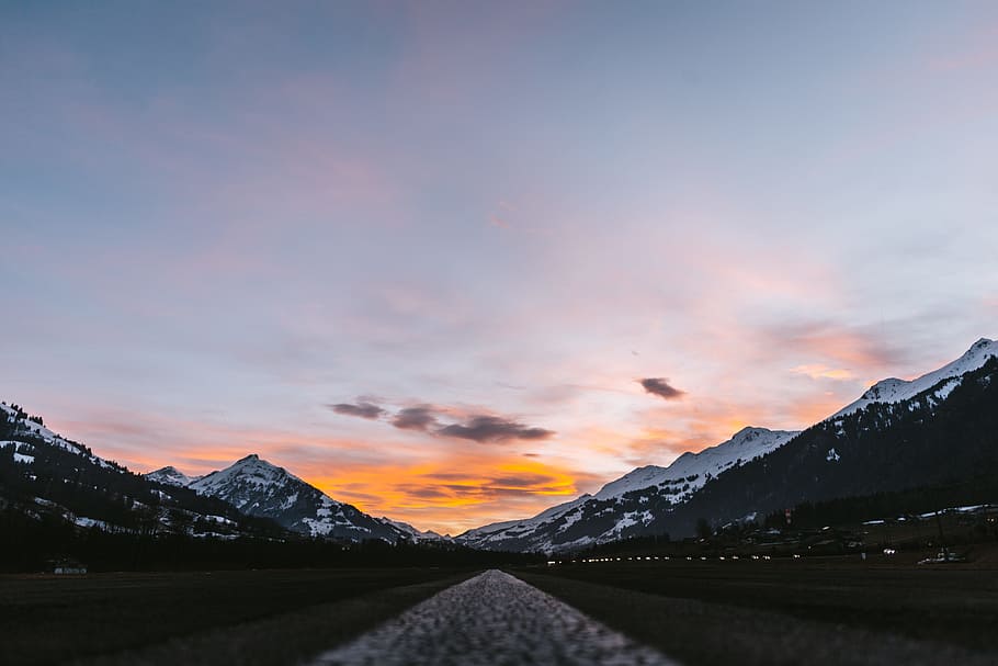 asphalt road near mountains, landscape photography of mountains under cloudy sky HD wallpaper