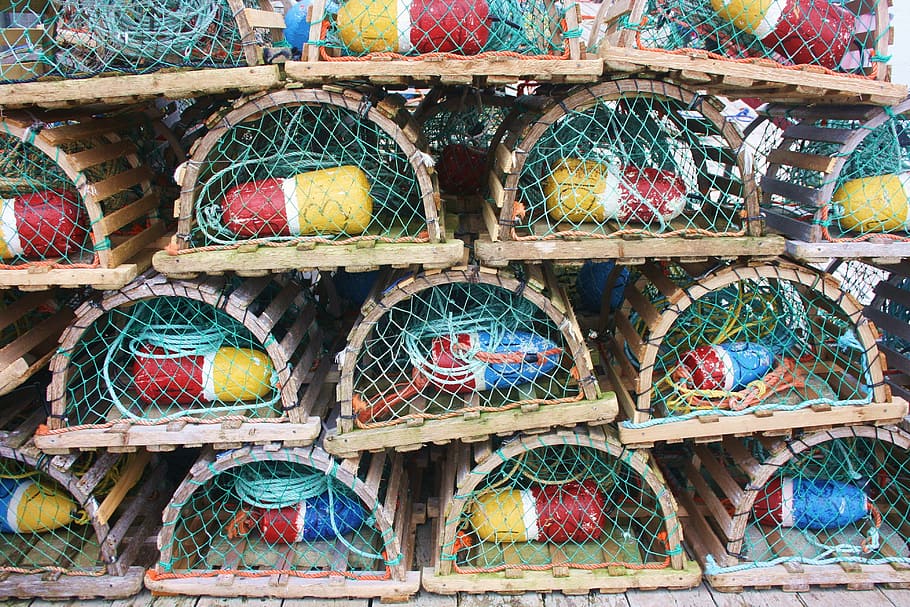 pile of dome-shaped brown wooden animal trap lot, lobster cage