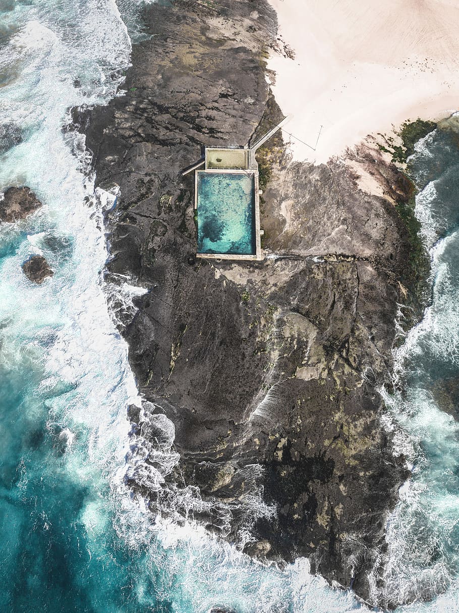 aerial photo of building on rock formation, aerial view of mountain HD wallpaper