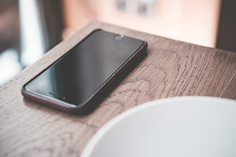 Black Smartphone on Wooden Table in Café, cafe, desk, iphone HD wallpaper