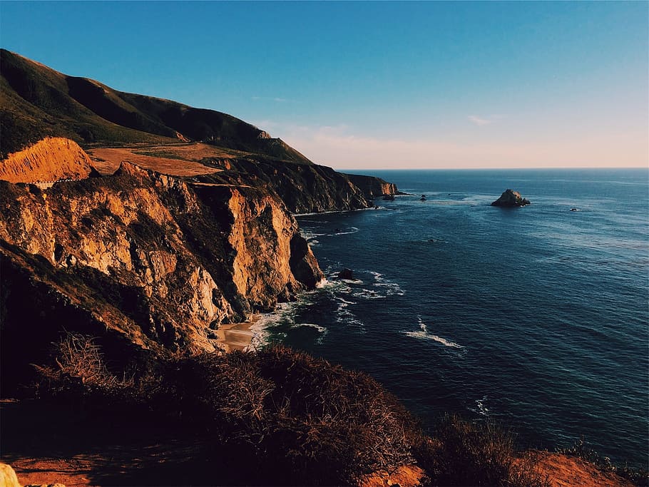 sunset, mountains, cliffs, coast, ocean, sea, waves, water HD wallpaper