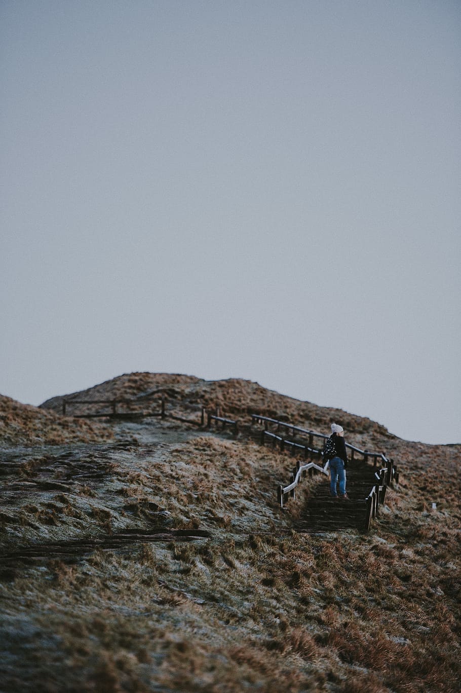 Woman climbing hill, woman stepping up on stair between open field during daytime HD wallpaper