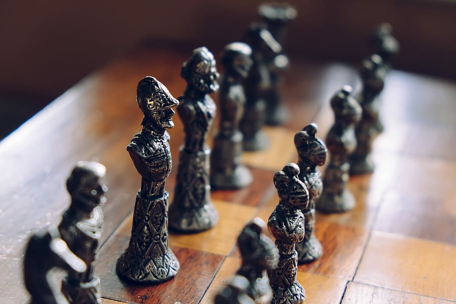 chess pieces on wooden chess board, chess piece set in tilt shift lens photo HD wallpaper
