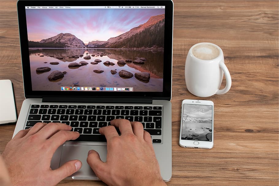 person using MacBook Pro, beside, white, ceramic, mug, silver HD wallpaper