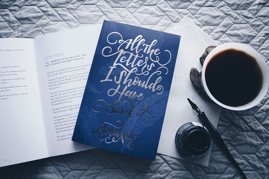 closed All the Letters I Should Have Sent novel book beside filled white cup, blue quote board beside of coffee mug and ink bottle HD wallpaper