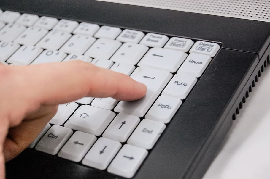 person pressing enter of black and white laptop computer, keyboard HD wallpaper