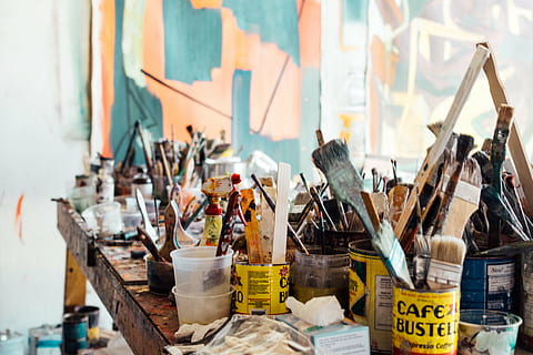 assorted paint cans and paintbrushes on brown wooden table HD wallpaper