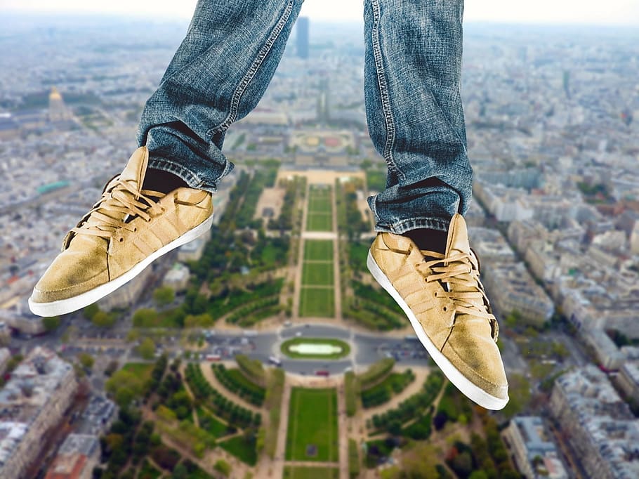 selective focus photo of person's feet wearing brown low-top sneakers HD wallpaper