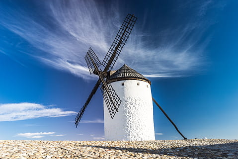 white lighthouse with black windmill under white clouds photography HD wallpaper