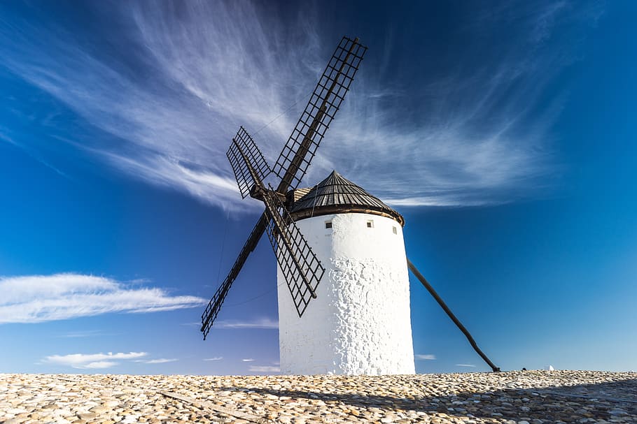 white lighthouse with black windmill under white clouds photography HD wallpaper