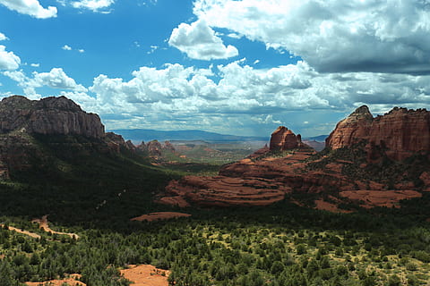 mountain peak during daytime, brown and green mountains under cloudy blue sky during daytime HD wallpaper