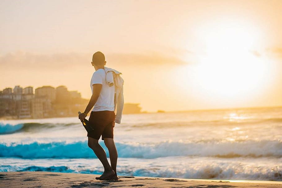 man wears white shirt on gray sand during sunsety, beach, thoughts HD wallpaper