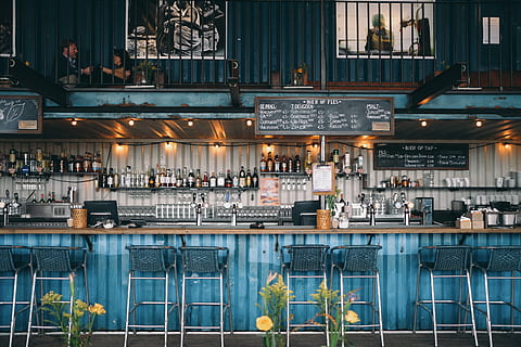 wine bottle lot on shelves inside abr, people in liquor bar, cafe HD wallpaper