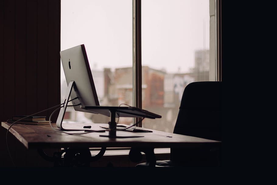 silver iMac on desk inside office, selective focus photography of monitor on desk near window pane HD wallpaper