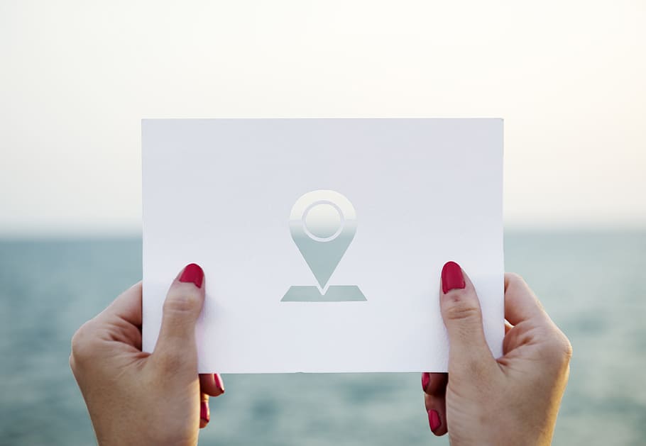 person holding paper with drop logo, Google Map, card, destination