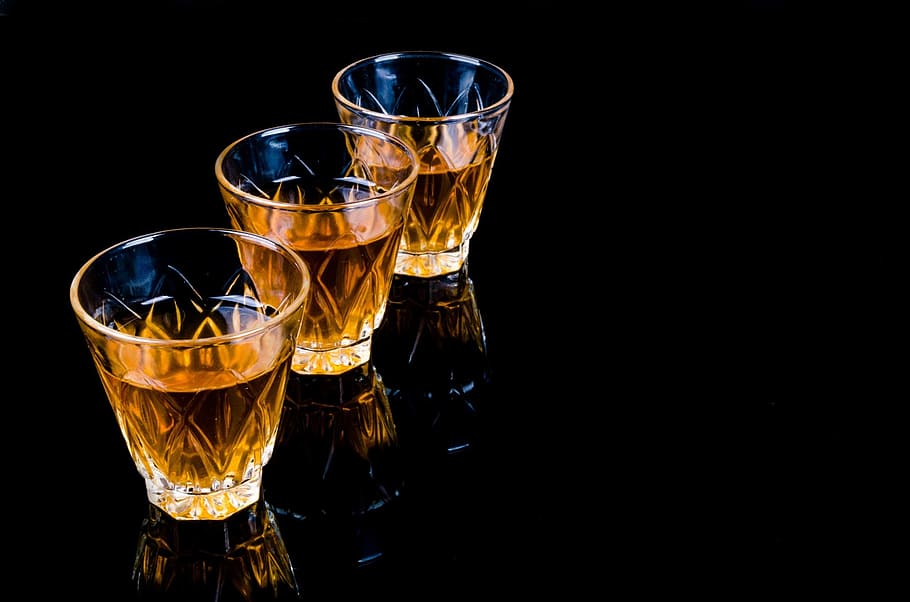 three clear shot glasses on black surface, bar, liquor, barman