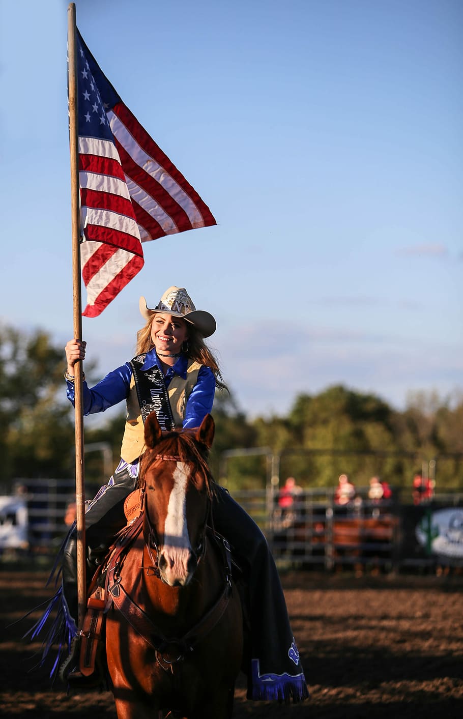 photo of woman riding on horse and holding flag, flagpole, female