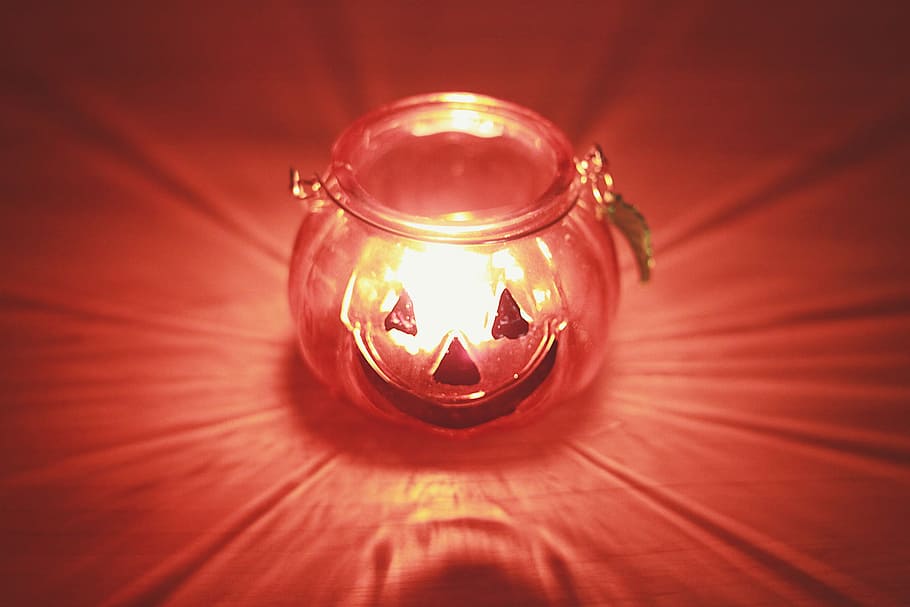 clear glass pumpkin bottle on red surface, lantern, flame, candle HD wallpaper