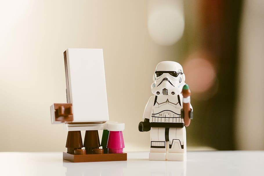 white Stormtroopers minifig, selective focus photography of stormtrooper on white surface