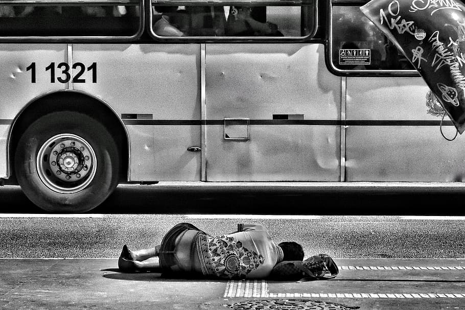 grayscale photography of person laying on ground near bus, grayscale photo of person lying on road beside bus HD wallpaper