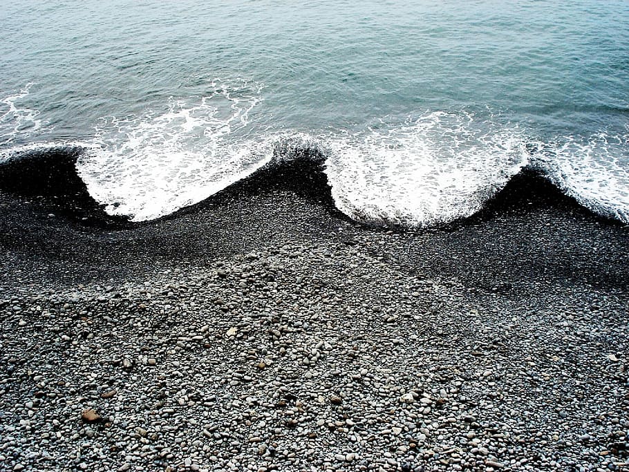 ocean waves hugging black beach sand, body of water at the seashore HD wallpaper