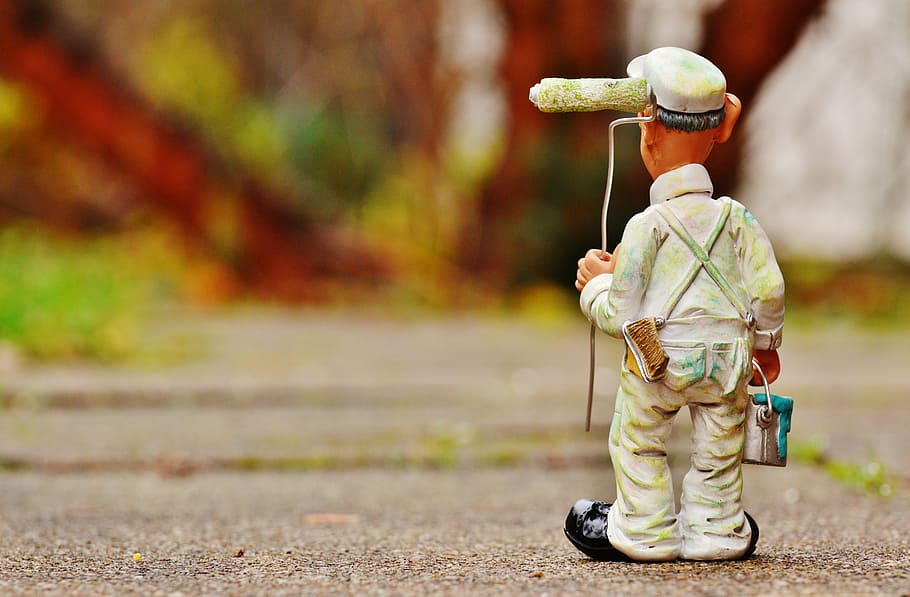 closeup photoghraphy of man holding paint can and paint roller on concrete road HD wallpaper