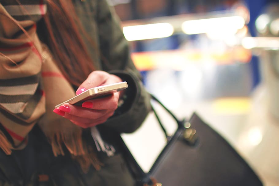 woman wearing black coat holding phone, iphone, mobile, technology HD wallpaper
