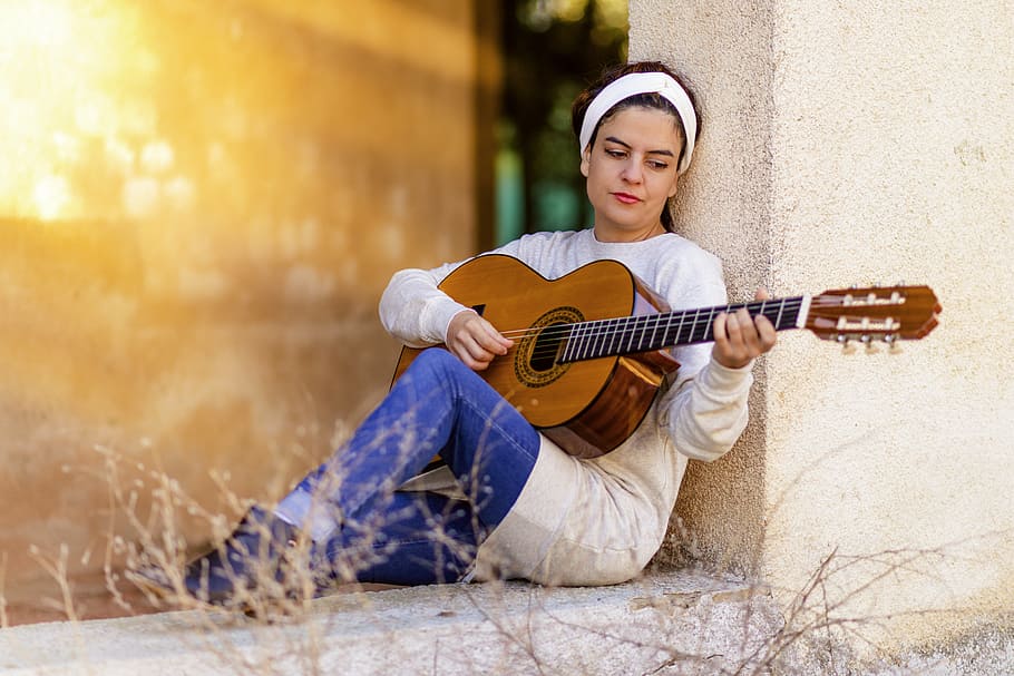 woman playing brown classical guitar, girl, music, instrument