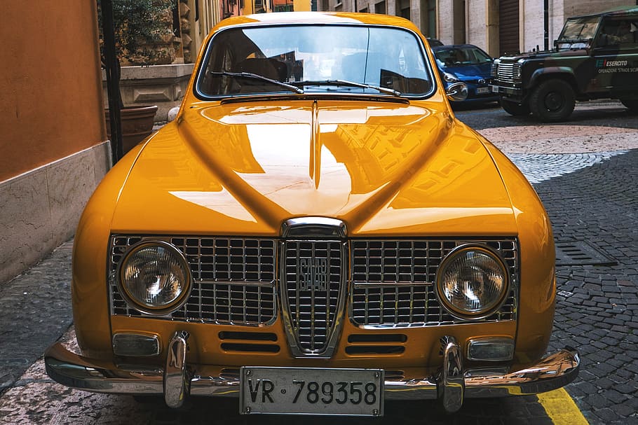 Classic old yellow Saab car, urban, street, transportation, retro Styled