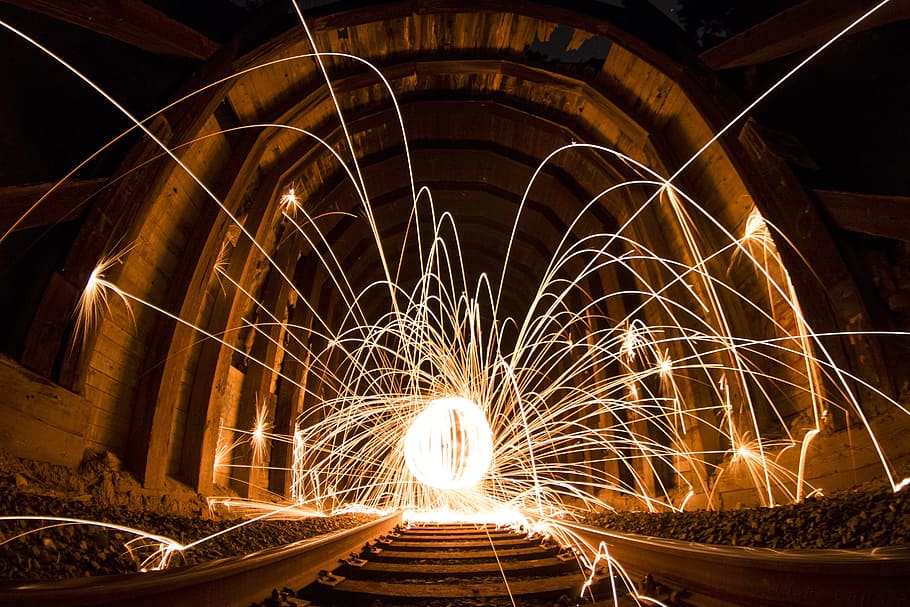 sparkler on train rail during nighttime, art, dark, light, light streaks HD wallpaper