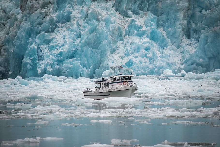 white boat surrounded by floating ice, white boat surrounded by ice