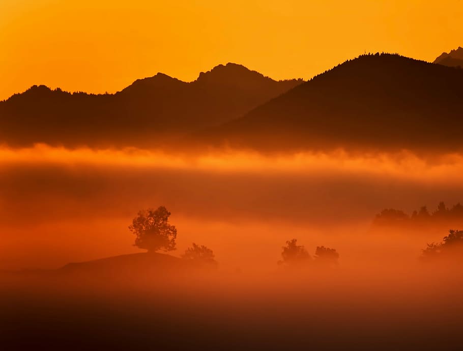 silhouette of mountain covered by fog, mountain silhouette covered by fogs during golden hour HD wallpaper