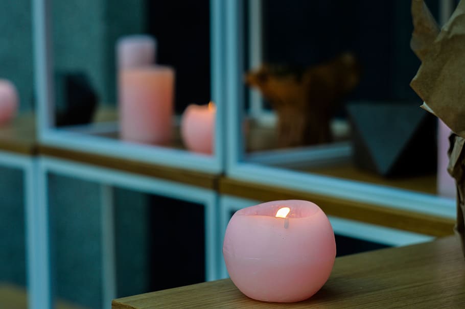 round pink candle on top of brown wooden table, lighting, window HD wallpaper
