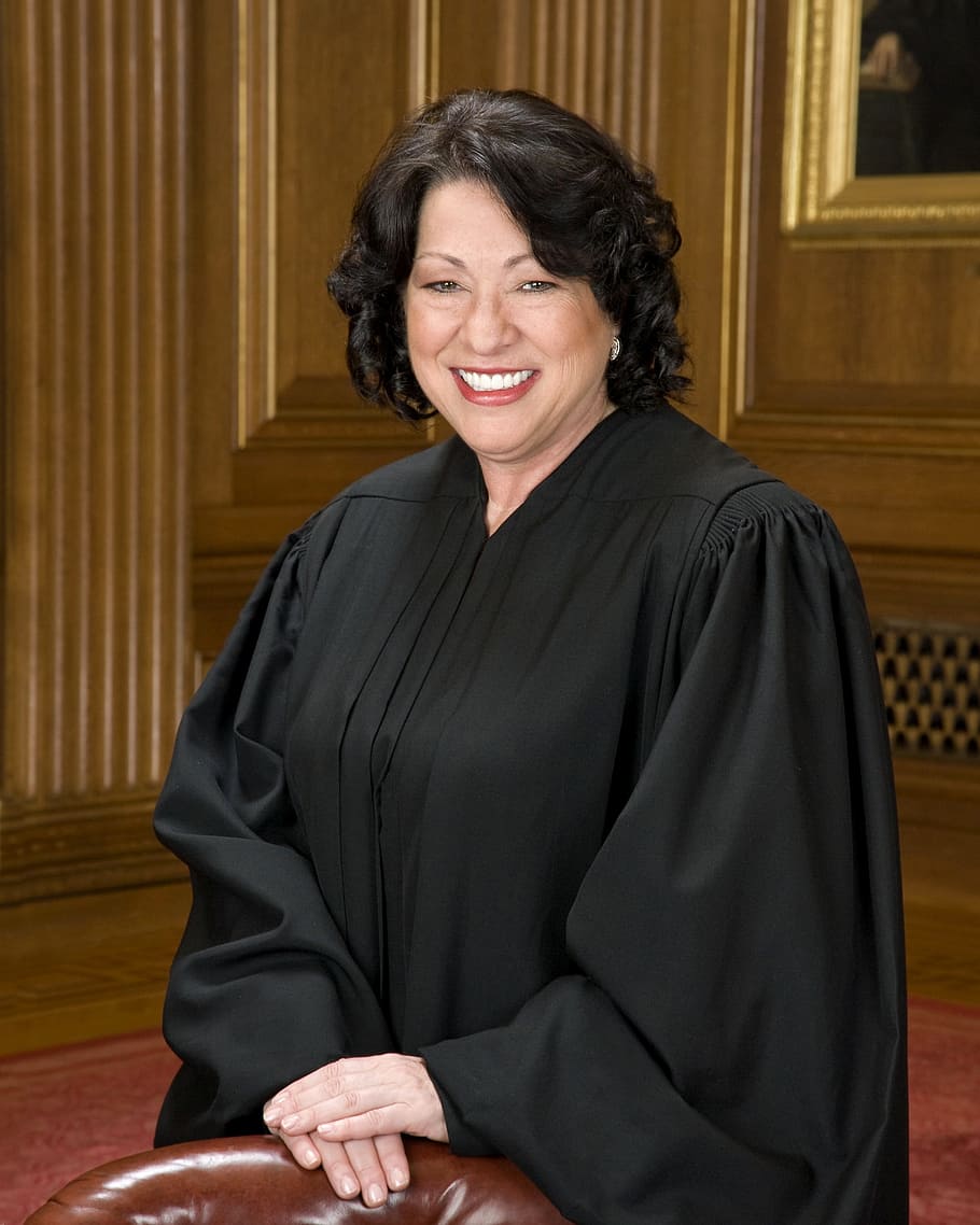 woman wearing black long-sleeved dress smiling, judge, court