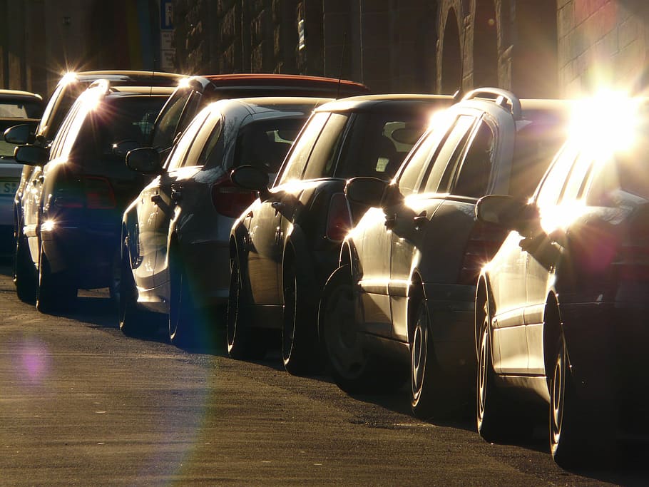 assorted cars in line near gray concrete wall during daytime HD wallpaper