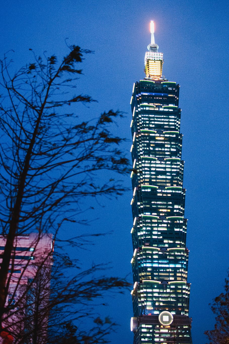 black concrete building during nighttime, low angle photography of highrise building HD wallpaper