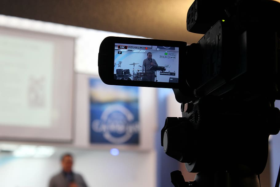 man wearing shirt filming in front of drum set in selective focus photography HD wallpaper
