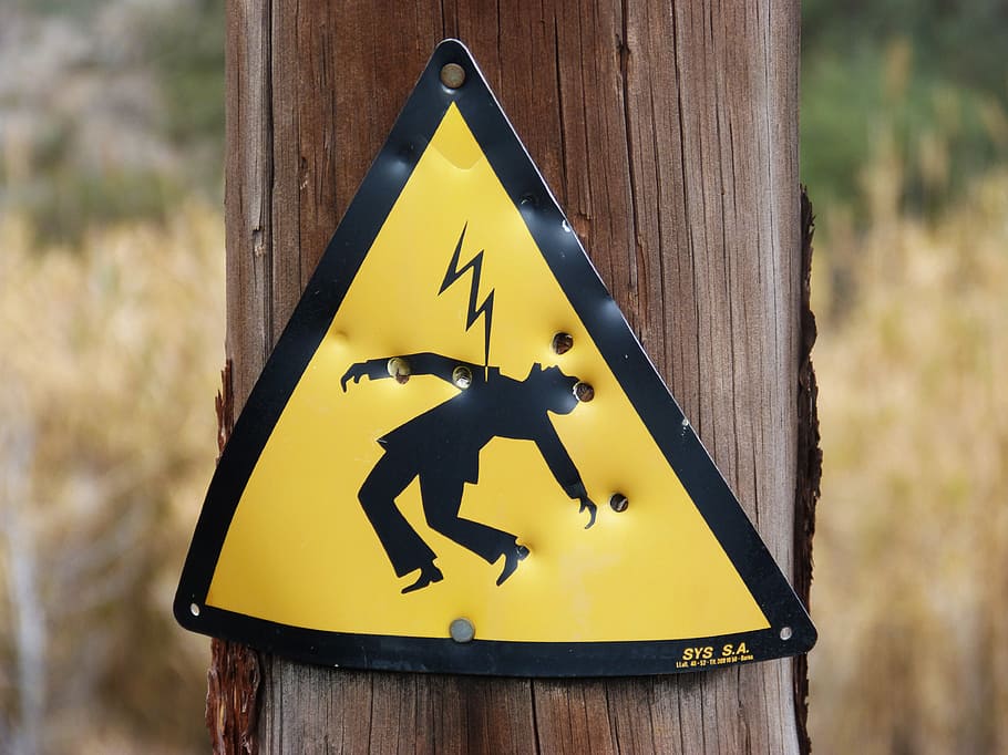 lightning hazard sign on wood post, danger, power line, electric shock